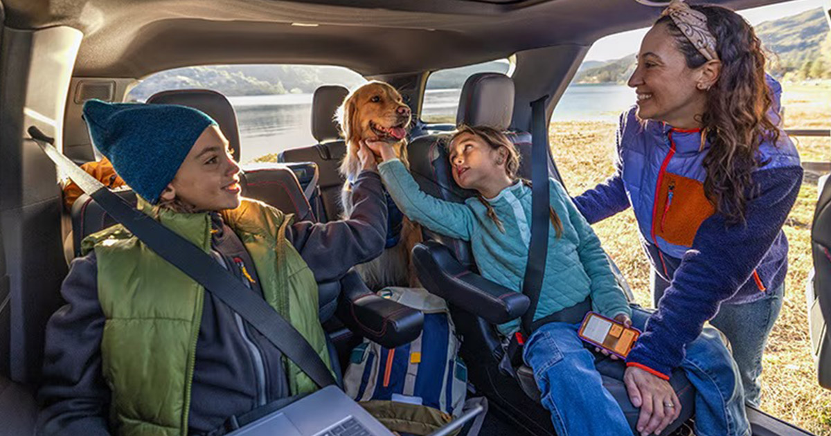 Family in a Ford vehicle with their dog.