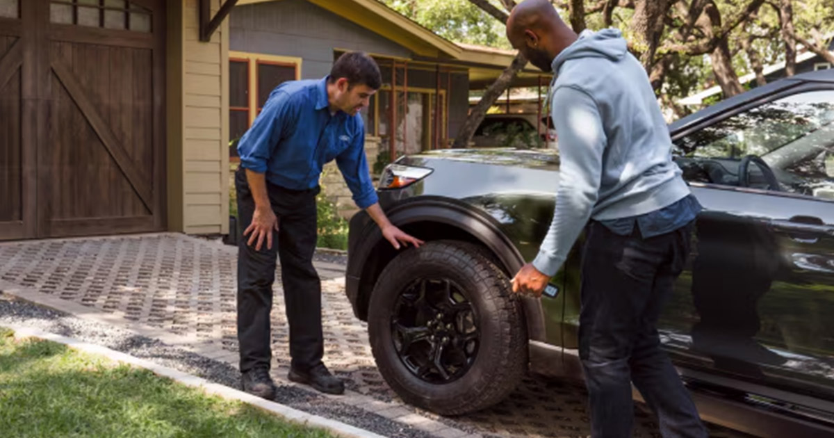 Ford Service technician checking tires on a ford vehicle.