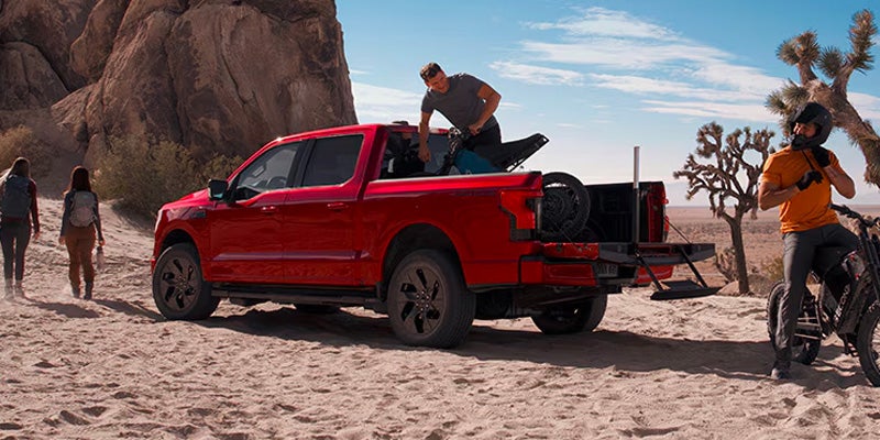 a Ford 2025 red F-150 Lightning in a desert terrain