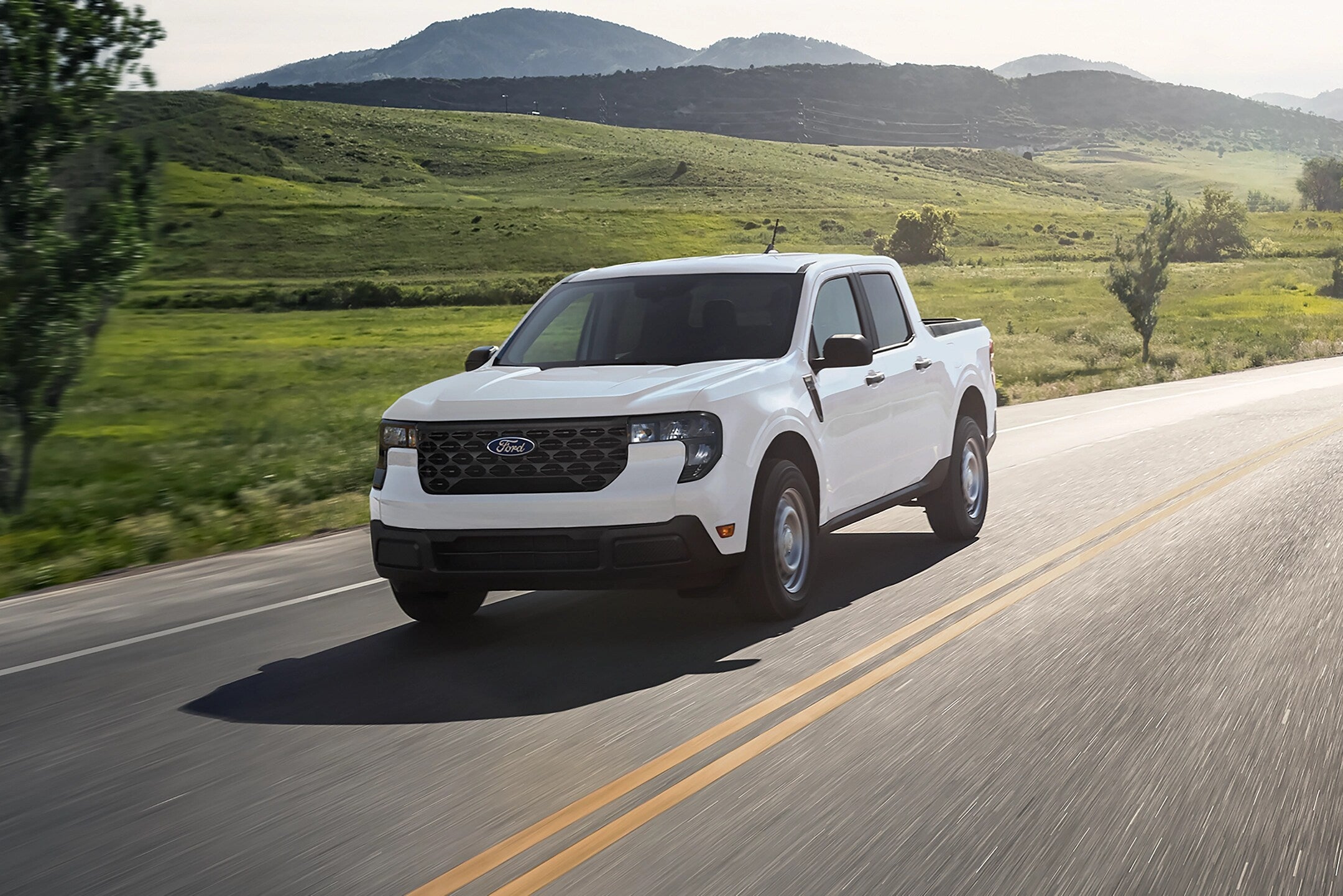 white Ford driving on road.
