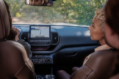 A close up look at the Ford Bronco Sport front interior with to woman in the driver/passenger seat